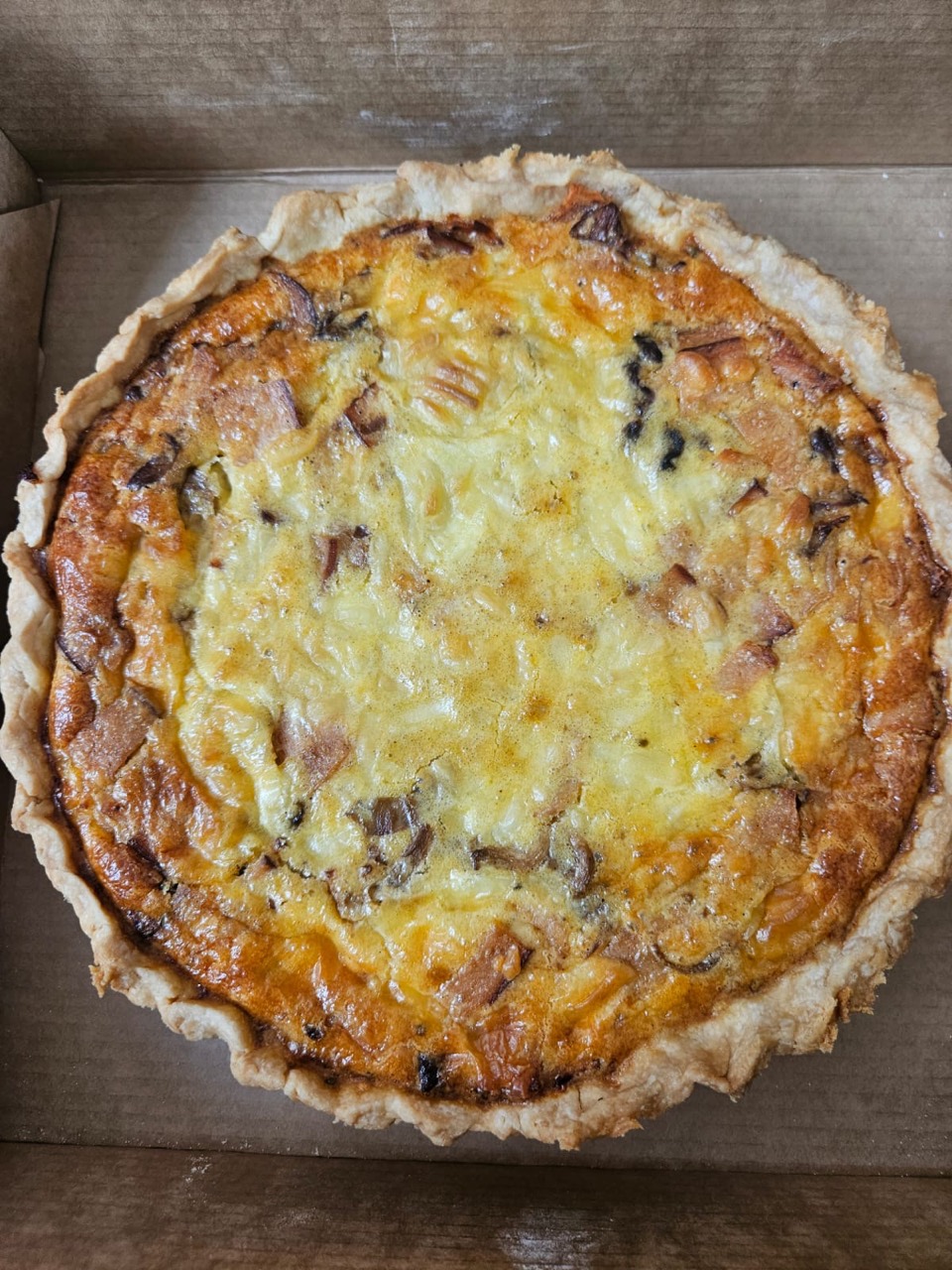 Freshly baked savoury quiche prepared for a catered gathering