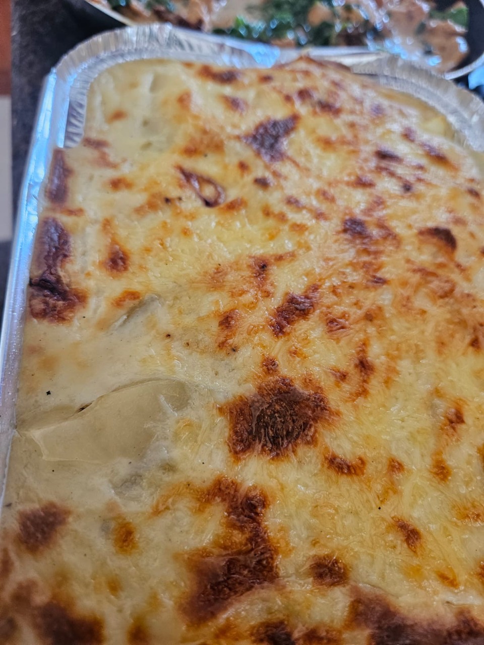 Golden baked gratin in a catering tray