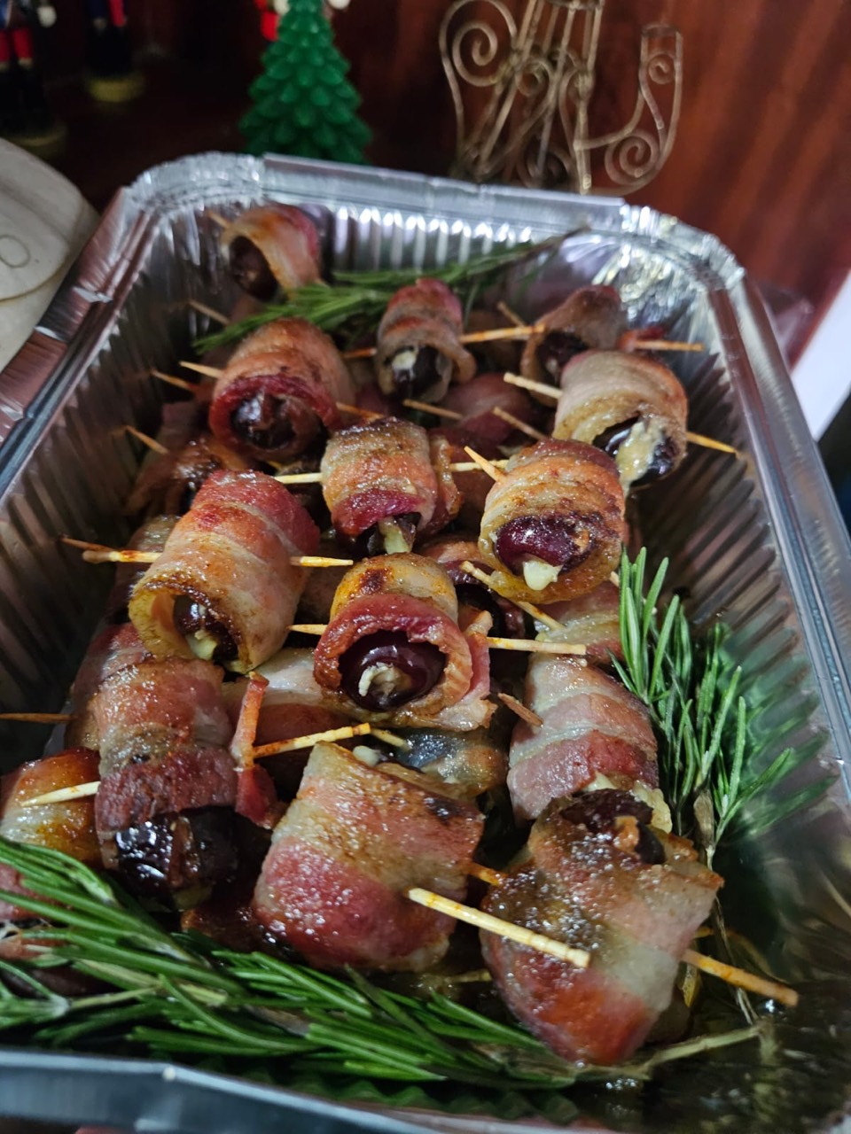 Bacon-wrapped stuffed dates prepared as party bites