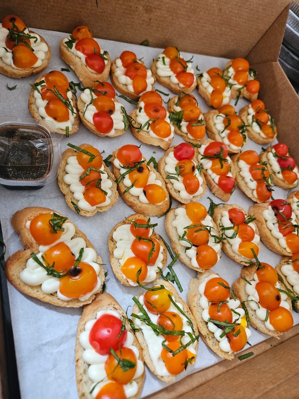 Tomato and cream-topped crostini finished with fresh basil