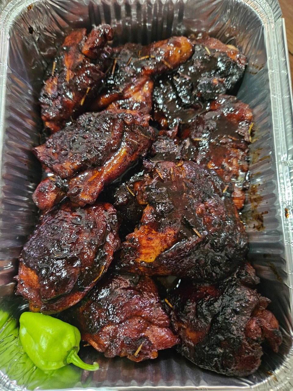 Richly glazed roasted meat prepared in a catering tray