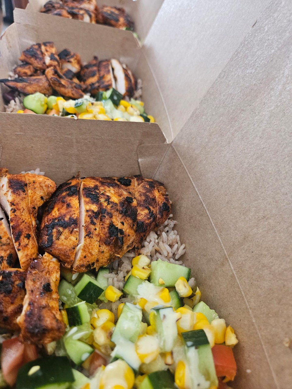 Prepared chicken, rice, cucumber, and sweetcorn meal boxes