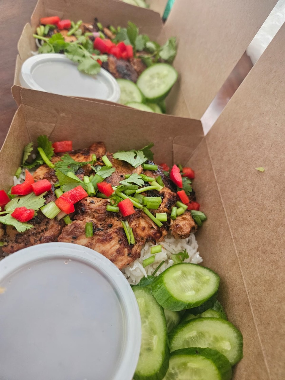 Chicken rice bowls with cucumber, herbs, and dressing