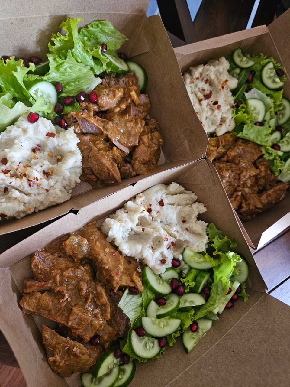 Prepared meat, mash, cucumber, and green salad meal boxes